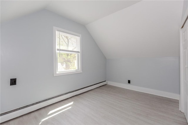 46 Freeman St, Warwick, RI 02886 - bonus room featuring baseboards, vaulted ceiling, baseboard heating, and light wood-style floors