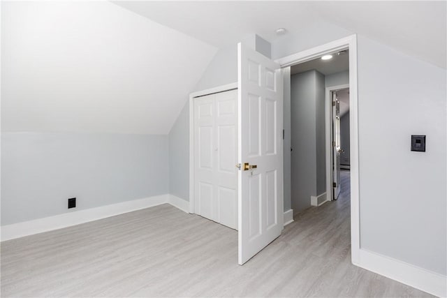 46 Freeman St, Warwick, RI 02886 - additional living space with baseboards, light wood-style flooring, and lofted ceiling