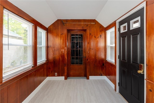 46 Freeman St, Warwick, RI 02886 - foyer entrance with light wood-type flooring, wood walls, and vaulted ceiling