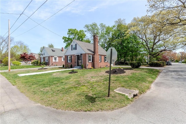 46 Freeman St, Warwick, RI 02886 - view of front facade featuring brick siding, a front lawn, and a chimney