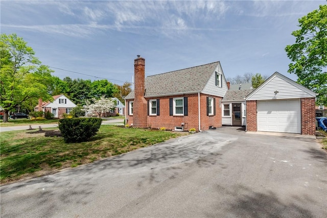 46 Freeman St, Warwick, RI 02886 - view of front facade with driveway, a chimney, a garage, brick siding, and a front lawn