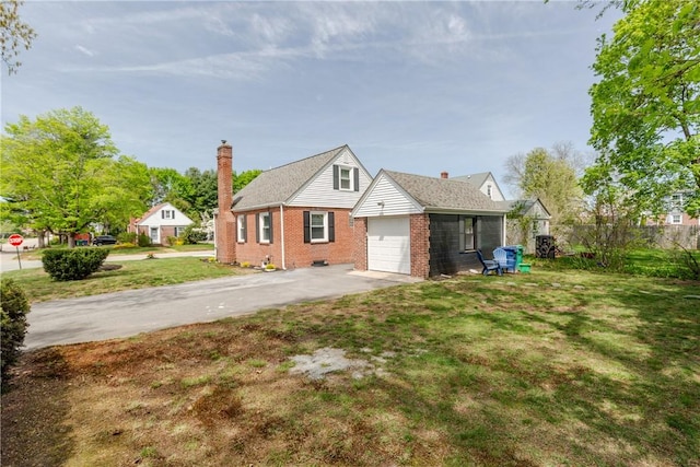 46 Freeman St, Warwick, RI 02886 - view of front of home with an attached garage, brick siding, a front yard, a chimney, and driveway