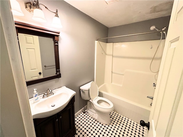 full bathroom featuring vanity, toilet, washtub / shower combination, tile patterned floors, and baseboards