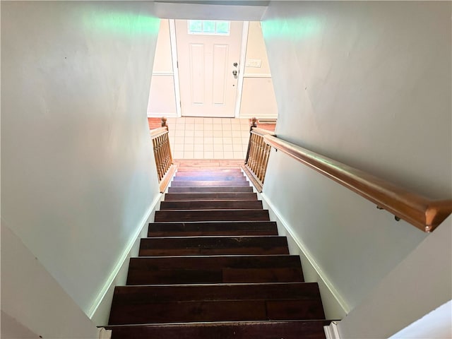stairway with wood finished floors
