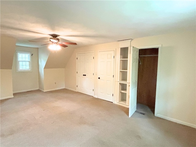 bonus room with a ceiling fan, carpet floors, and baseboards