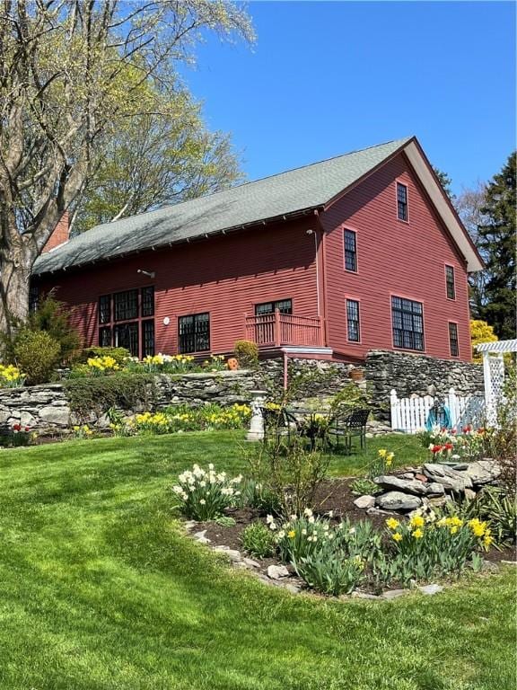 view of side of home featuring a yard and a chimney