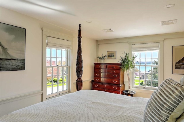 bedroom featuring visible vents and multiple windows
