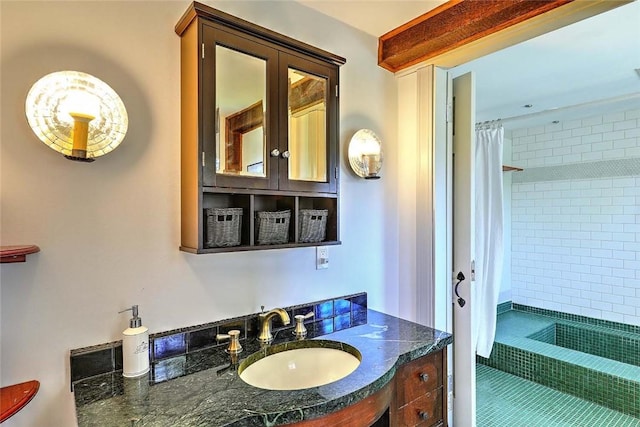 full bathroom featuring vanity, tile patterned flooring, and tiled shower