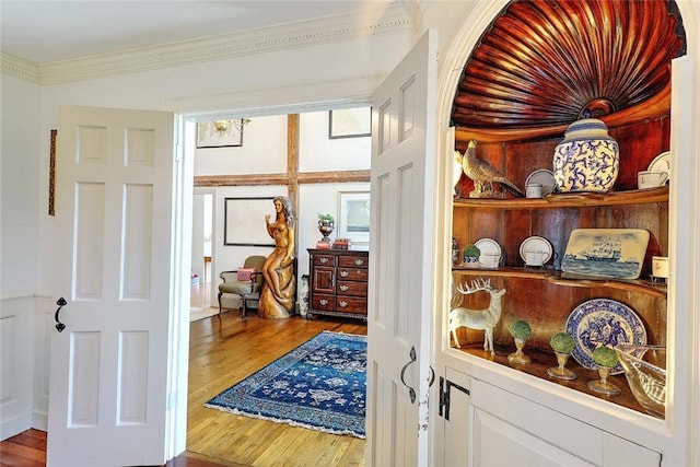 hall featuring crown molding and wood finished floors