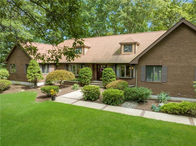 10 Oak Hill Dr, Lincoln, RI 02865 - view of front of house featuring roof with shingles, a front yard, and brick siding
