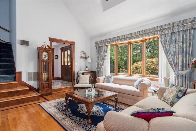 10 Oak Hill Dr, Lincoln, RI 02865 - living area featuring visible vents, high vaulted ceiling, wood finished floors, and stairs