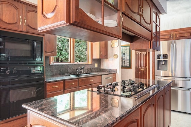 10 Oak Hill Dr, Lincoln, RI 02865 - kitchen featuring dark stone counters, a sink, brown cabinets, decorative backsplash, and black appliances