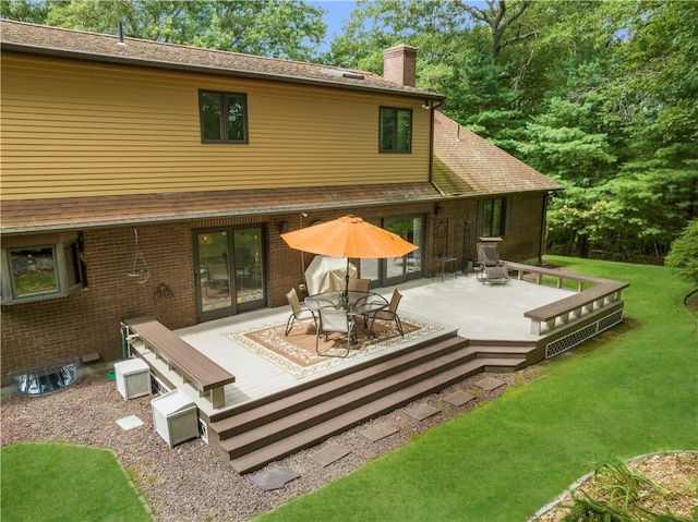10 Oak Hill Dr, Lincoln, RI 02865 - rear view of property featuring a lawn, a wooden deck, a chimney, and brick siding