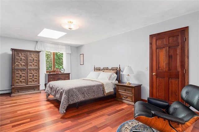 10 Oak Hill Dr, Lincoln, RI 02865 - bedroom featuring a skylight, light wood-style floors, and a baseboard radiator