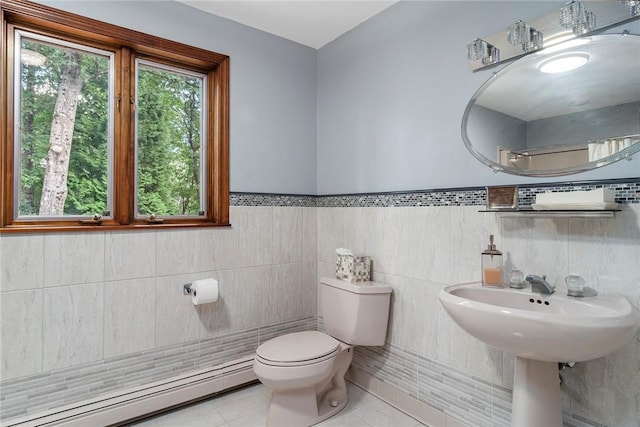 10 Oak Hill Dr, Lincoln, RI 02865 - bathroom featuring a baseboard heating unit, tile walls, tile patterned floors, toilet, and wainscoting