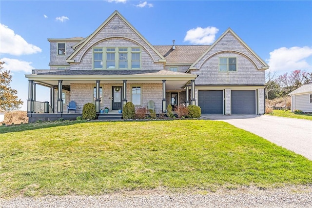view of front of home featuring a front lawn, covered porch, aphalt driveway, and an attached garage
