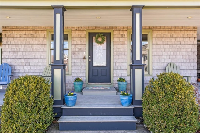 view of exterior entry with covered porch