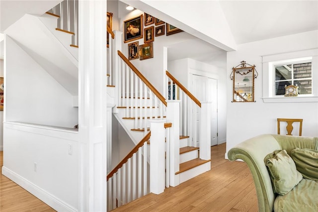 stairway featuring wood finished floors and baseboards
