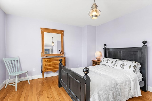 bedroom featuring light wood-style flooring and baseboards