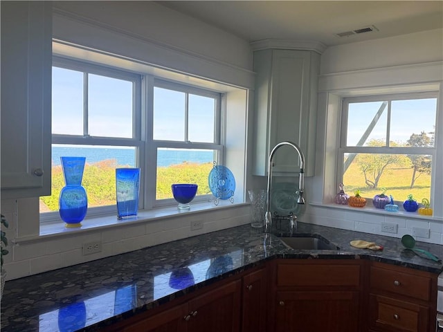 7 Clarkes Village Rd, Jamestown, RI 02835 - kitchen featuring visible vents, a sink, and dark stone countertops