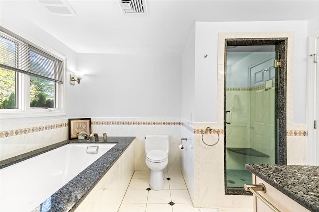 bathroom with tile patterned flooring, a shower stall, toilet, visible vents, and a garden tub