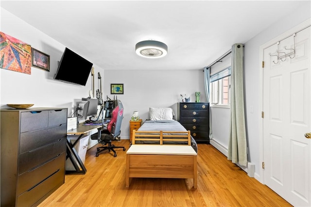 bedroom featuring light wood-style floors and baseboards