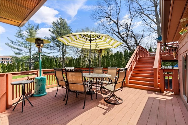 wooden deck with stairs and outdoor dining area