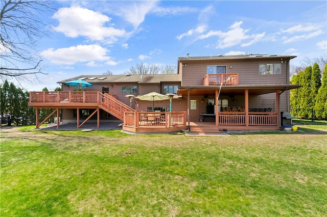 back of property with a yard, stairs, a wooden deck, and a balcony