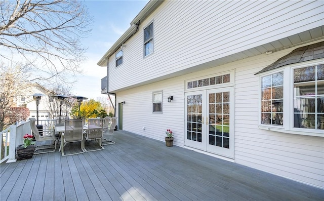 wooden deck featuring french doors and outdoor dining area