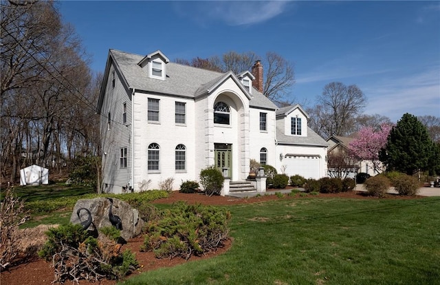 view of front of home with a chimney and a front lawn