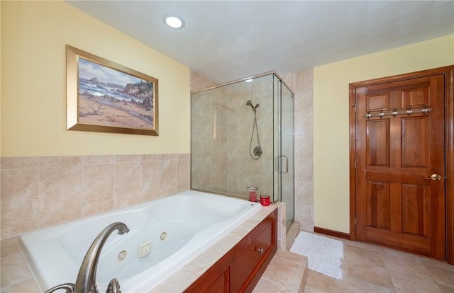 full bathroom featuring a tub with jets, tile patterned flooring, and a shower stall