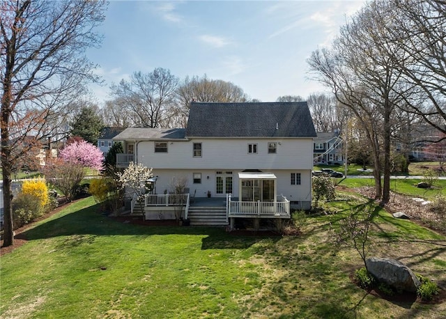 back of house featuring a lawn and a deck