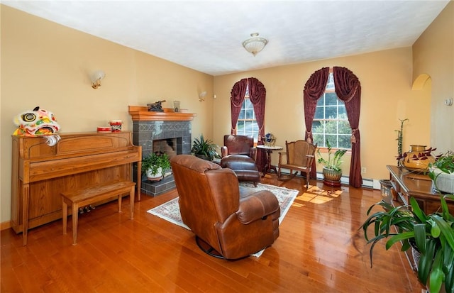 living area featuring wood finished floors and a tile fireplace