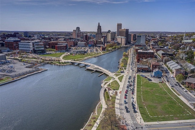 drone / aerial view featuring a view of city and a water view