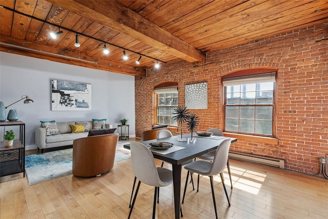dining room with wood-type flooring, track lighting, a baseboard radiator, and wood ceiling