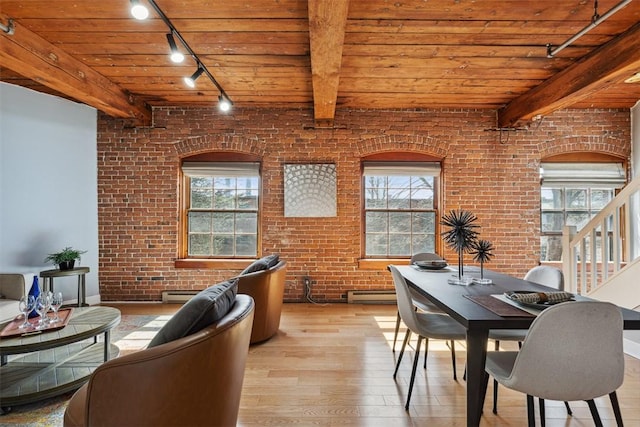 dining area with track lighting, wooden ceiling, plenty of natural light, and wood-type flooring