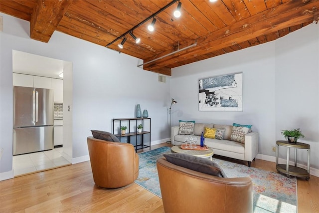 living area with light wood finished floors, track lighting, wooden ceiling, and baseboards