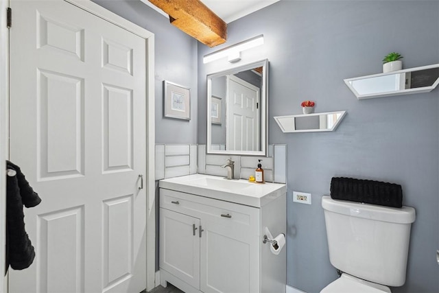 bathroom featuring toilet and vanity