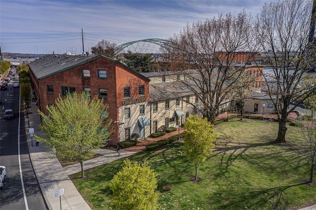 exterior space featuring a lawn and brick siding