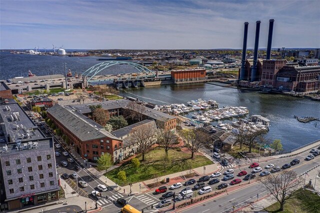 drone / aerial view featuring a city view and a water view