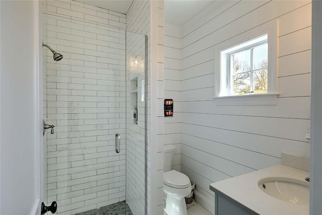 full bathroom featuring vanity, a stall shower, and toilet