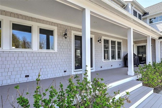 doorway to property featuring covered porch
