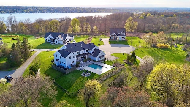 birds eye view of property featuring a view of trees