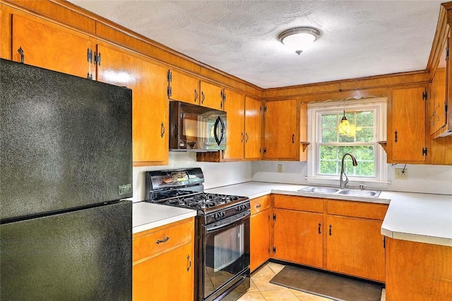 4 Johnson Ct, Bristol, RI 02809 - kitchen with black appliances, a sink, brown cabinets, light countertops, and light tile patterned flooring