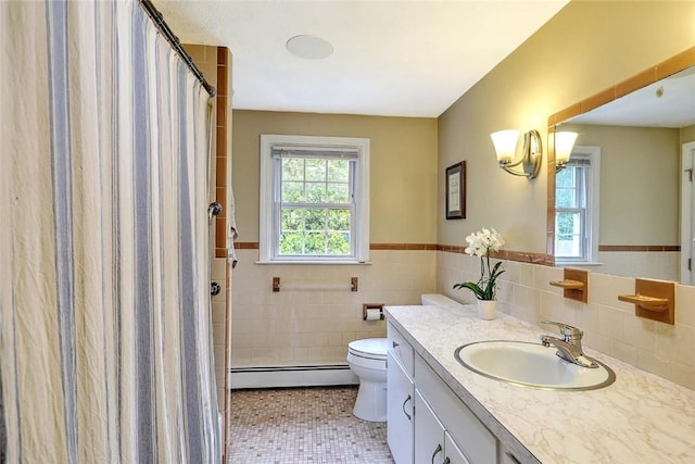 4 Johnson Ct, Bristol, RI 02809 - bathroom featuring a baseboard heating unit, vanity, tile walls, toilet, and tile patterned flooring