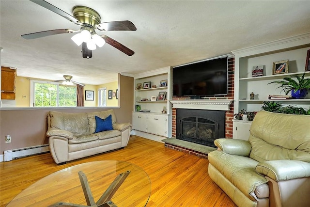 4 Johnson Ct, Bristol, RI 02809 - living room with a baseboard radiator, light wood-style flooring, ceiling fan, and a fireplace