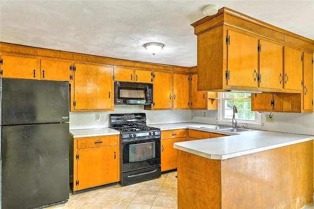 4 Johnson Ct, Bristol, RI 02809 - kitchen with black appliances, a sink, brown cabinetry, light countertops, and a peninsula