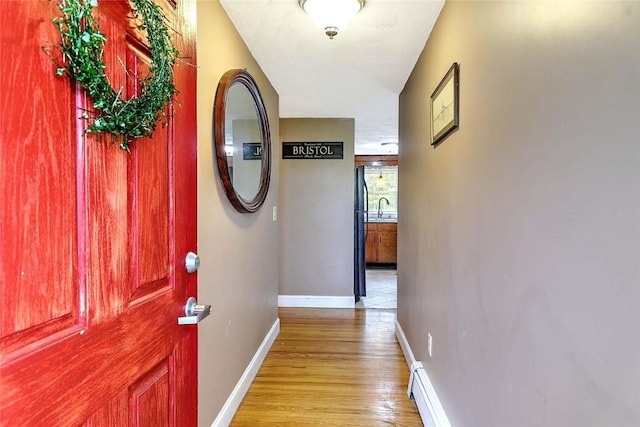 4 Johnson Ct, Bristol, RI 02809 - corridor featuring wood finished floors, baseboards, and a sink