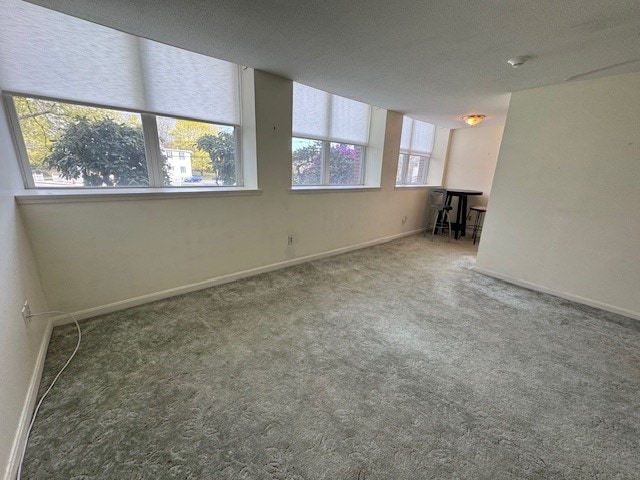140 High St Unit 108, Westerly, RI 02891 - unfurnished living room featuring carpet flooring and baseboards