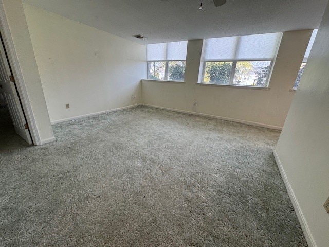140 High St Unit 108, Westerly, RI 02891 - unfurnished room with a ceiling fan, visible vents, carpet floors, and baseboards